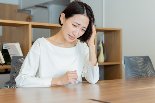 頭痛で悩む女性 頭痛で悩む女性